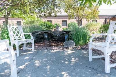 Outdoor space with seating and a water feature