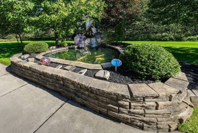 A serene outdoor pond with landscaping features