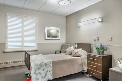 Bright resident room with a bed and natural light