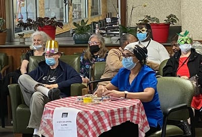 Residents participating in a game activity indoors