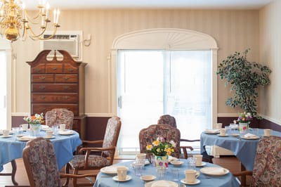 Bright dining room with set tables and floral decorations