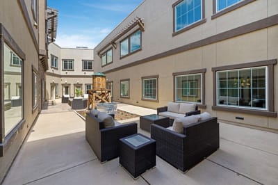 Outdoor courtyard with seating area and play structure