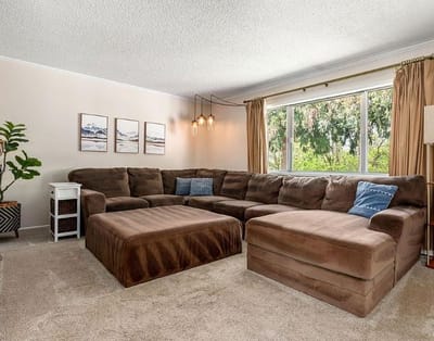 Cozy common area with a large sectional sofa and natural light