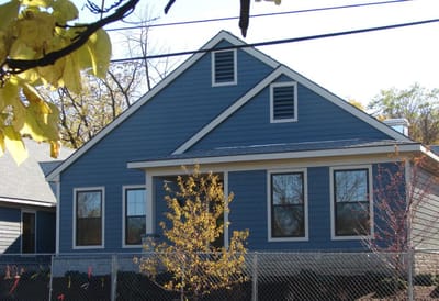Exterior view of a blue building with trees