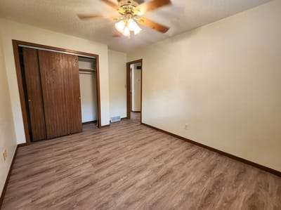 Interior view of a spacious room with wood flooring