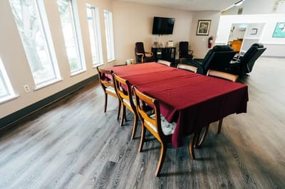 Common area with chairs and tables in a senior living facility
