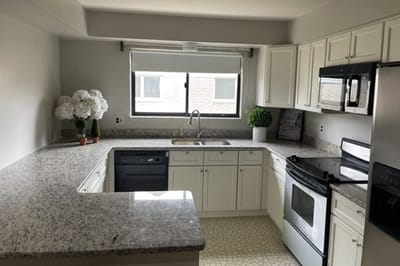 Modern kitchen with white cabinets and appliances