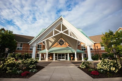 Entrance of a senior living facility with landscaping