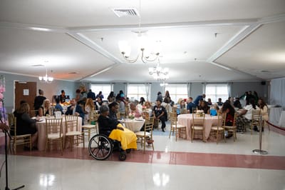 A vibrant gathering in a common area with residents and staff