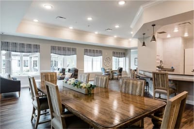 Bright, spacious common area with dining tables