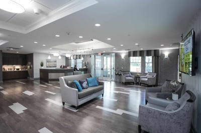 Bright lobby area with seating and a reception desk