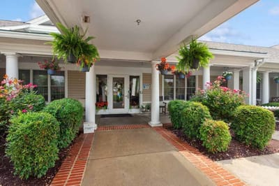 Entrance of HeartFields Assisted Living with vibrant flowers