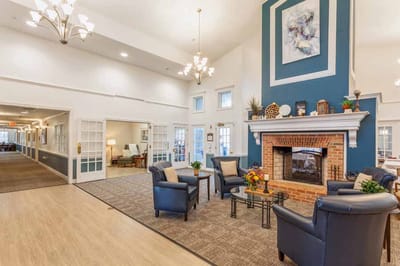 Bright common area with seating and a fireplace