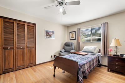 Cozy resident room with a bed and chair