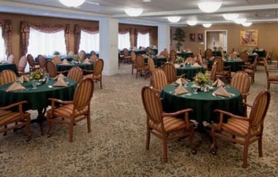 Dining room set for a meal with tables and chairs