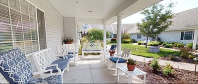 Outdoor seating area with plants in a senior living facility