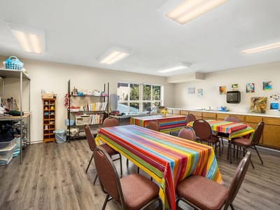 Bright craft room with colorful tables and chairs