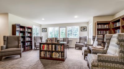 A cozy library area with bookshelves and seating