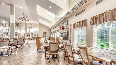 Bright dining area with large windows and wooden furniture