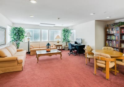 Bright common area with seating and bookshelves
