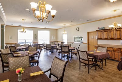 Dining room with tables set for residents
