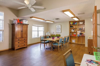 Bright activity room with tables and storage