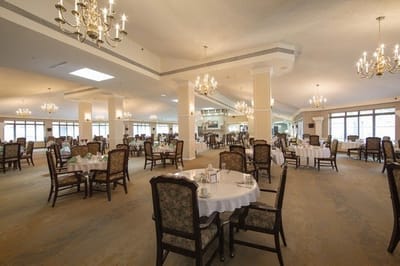 Spacious dining room with elegant lighting and tables