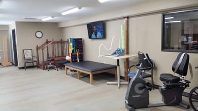 Interior view of a therapy room with exercise equipment