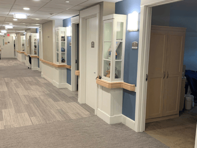 Hallway with cabinets and doors in a senior living facility