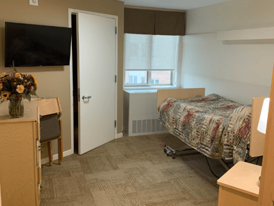 Cozy resident room with bed and TV