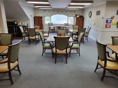 Bright common area with dining tables and chairs