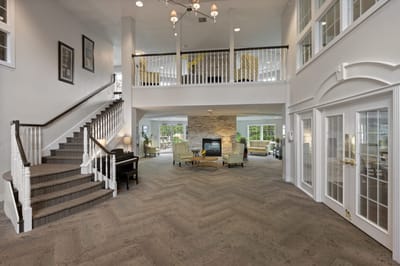 Bright common area featuring seating and stairs