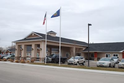 Exterior view of the facility entrance with flags