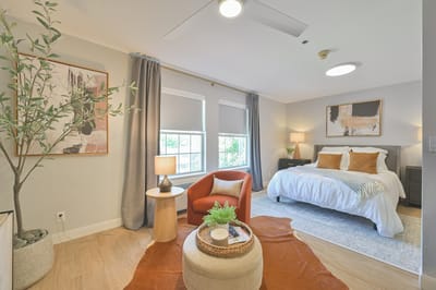 A cozy private room with a bed and seating area