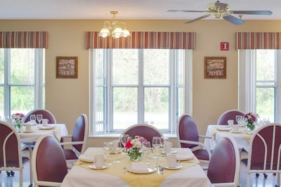 A bright dining room setup with tables for meals
