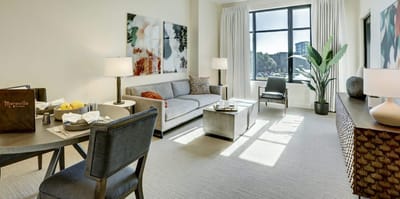 Bright and modern resident room with sofa and dining table