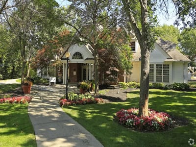 Exterior view of a senior living facility with landscaped gardens