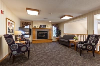 Bright common area with comfortable seating and a fireplace