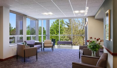 Bright common area with seating and large windows