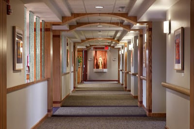 Quiet interior hallway with artwork and lighting