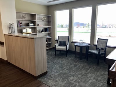 Cozy lounge area with seating and a bookshelf
