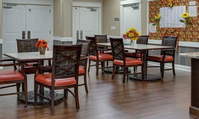 Dining area setup with tables and flowers