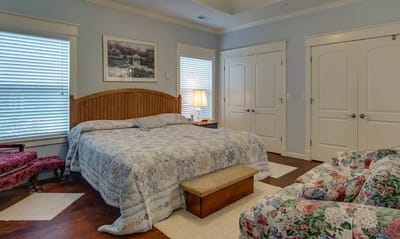 Cozy interior of a resident room with a bed and seating area