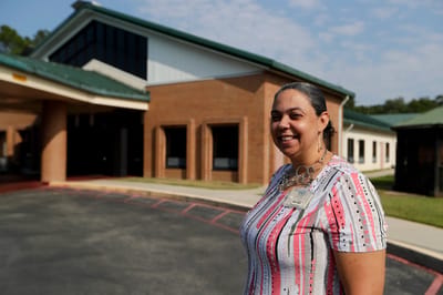 Staff member outside the nursing home building