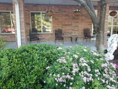 Outdoor seating area with greenery and flowers
