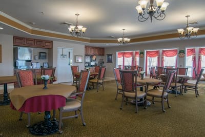 Dining room with tables and chairs set for residents