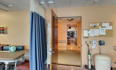 Therapy room entrance with equipment and amenities visible