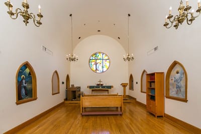 Interior of a chapel with stained glass window