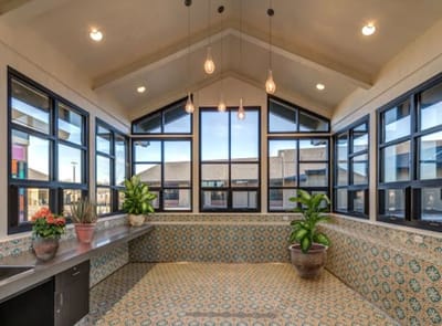 Bright interior space with large windows and decorative tiles