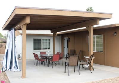 Outdoor shaded seating area with tables and chairs